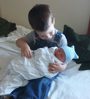 Big brother Bowen is holding Finnian